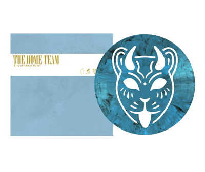 A limited edition opaque cyan vinyl by The Home Team features a white stylized cat face, comes with a matching blue "Live at Abbey Road" cover, and includes a color printed inner sleeve.