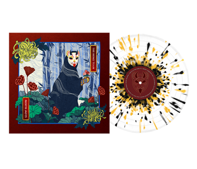 An illustrated album cover for The Home Team shows a figure in a fox mask and dark cloak in a forest with red flowers, beside an opaque white vinyl. The limited edition 12" jacket features a black and yellow splatter design.