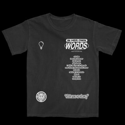Image of a black tshirt against a transparent background. The  tshirt features words and symbols, all in the color white. The right chest has a lightbulb symbol. Across from that it says in her own words. below that is the tracklisting for their album distance or decay. the bottom right is a symbol of a smiley face with x's for eyes, around the smiley it says I think I'm leaving forever. The bottom left says "distance or decay".