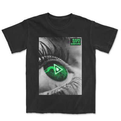 Image of a black tshirt against a transparent background. The shirt features a rectangular image that has a close up photo of an eye inside of it. The right corner says "rain city drive" in green. The photo is in black and white, except for the eye which is green and the center of it has a triangle with a raindrop inside of it.