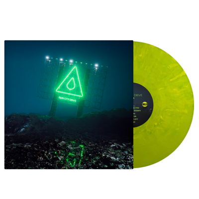 Image of the Rain city drive self titled album as a vinyl sleeve and vinyl against a transparent background. The vinyl, a slime green and yellowish color, is sticking halfway out of the vinyl sleeve. The vinyl sleeve features an image of a neon green sign lit up at night, that says rain city drive. Above that is an image of a triangle with a raindrop in the center of it. The ground surrounding the sign is rocky.